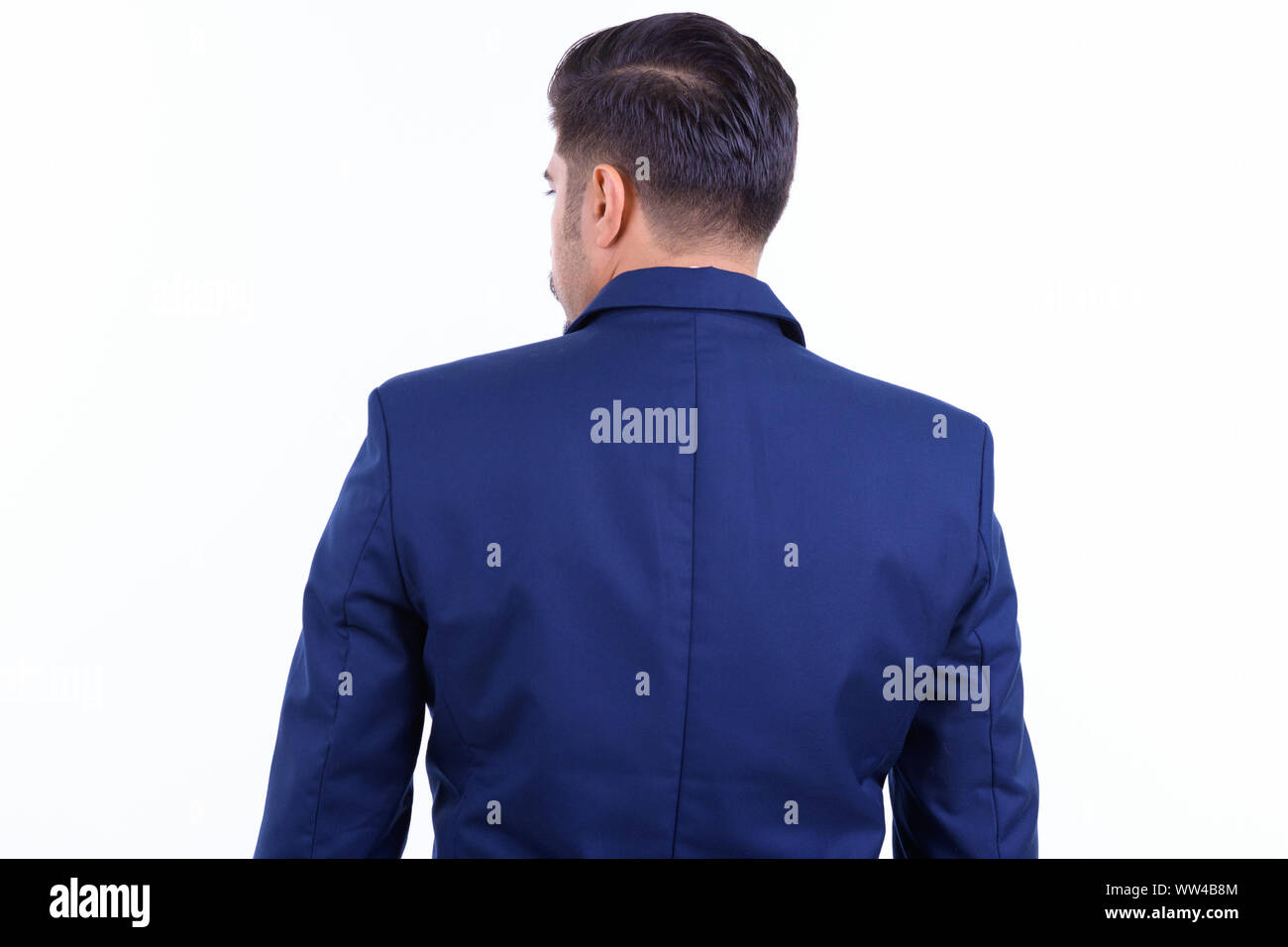Rear view of bearded Persian businessman looking over shoulder Stock Photo