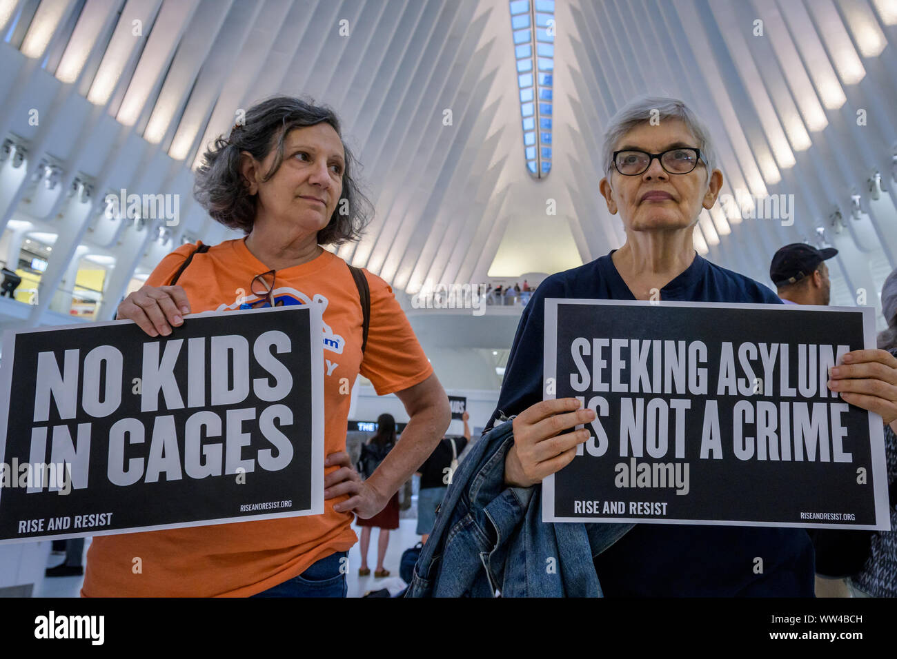New York, USA. 12th Sep, 2019. Members of the activist group Resist gathered a silent protest inside The Oculus on September 12, 2019 holding NO RAIDS/CLOSE THE CAMPS/ABOLISH ICE banners, photographs of the children who have died in ICE custody, and photographs of the detention camps to object to Border Patrol and ICE treatment of immigrants, refugees, and asylum seekers. Credit: Erik McGregor/ZUMA Wire/Alamy Live News Stock Photo