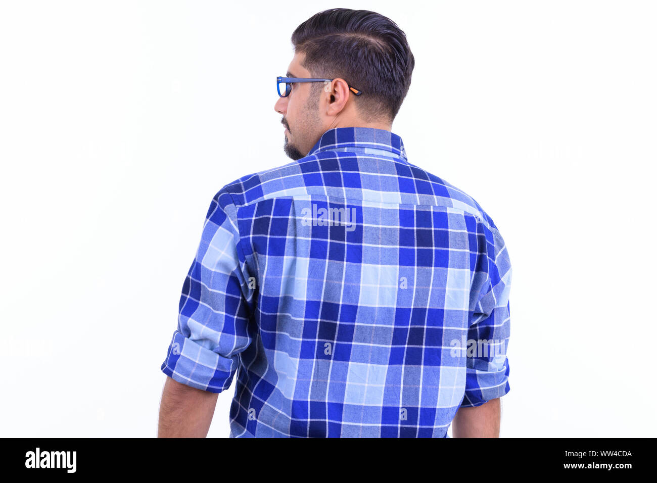 Rear view of bearded Persian hipster man looking over shoulder Stock Photo
