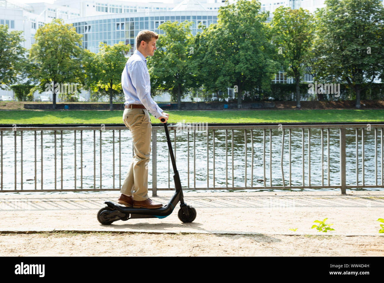 Young Man Riding An Electric Kick Scooter Stock Photo