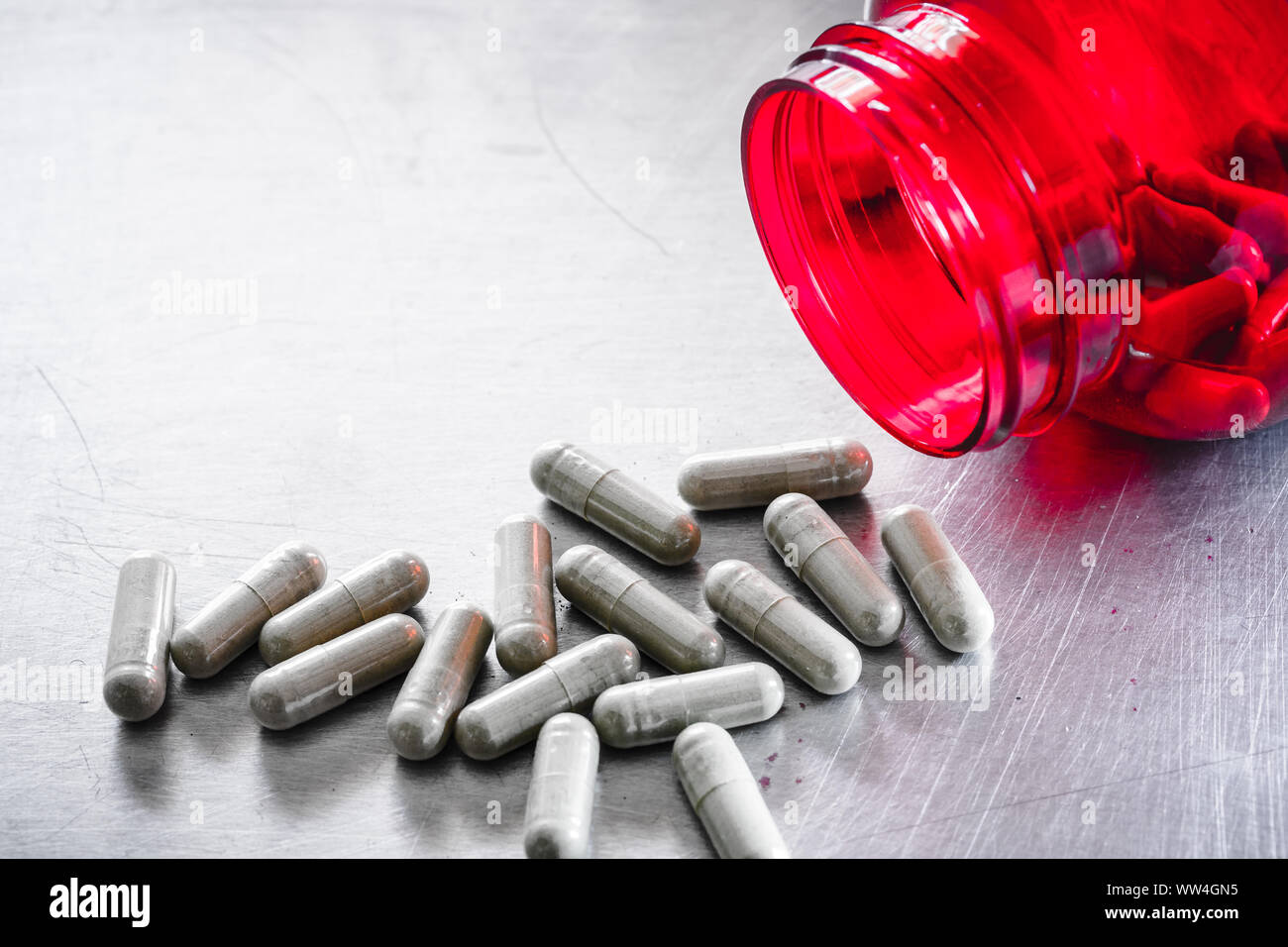 medical capsule from red bottle for danger of drug overdose heath care concept Stock Photo