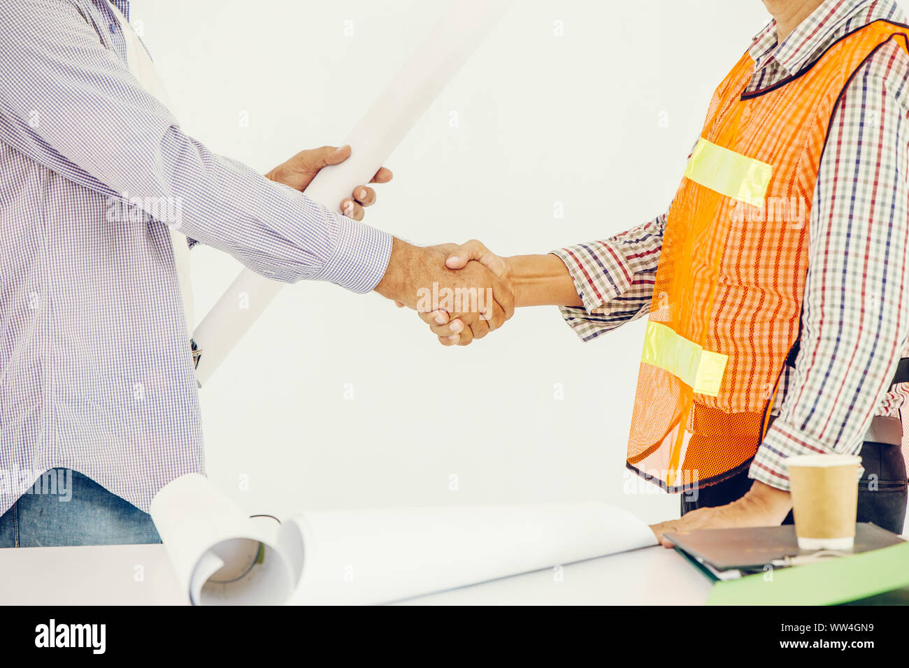 worker shaking hand deal job working together builder and designer Stock Photo