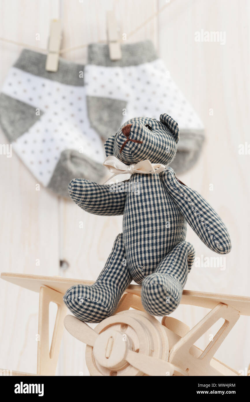 Cute teddy bear on wooden background with wooden baby toys Stock Photo ...