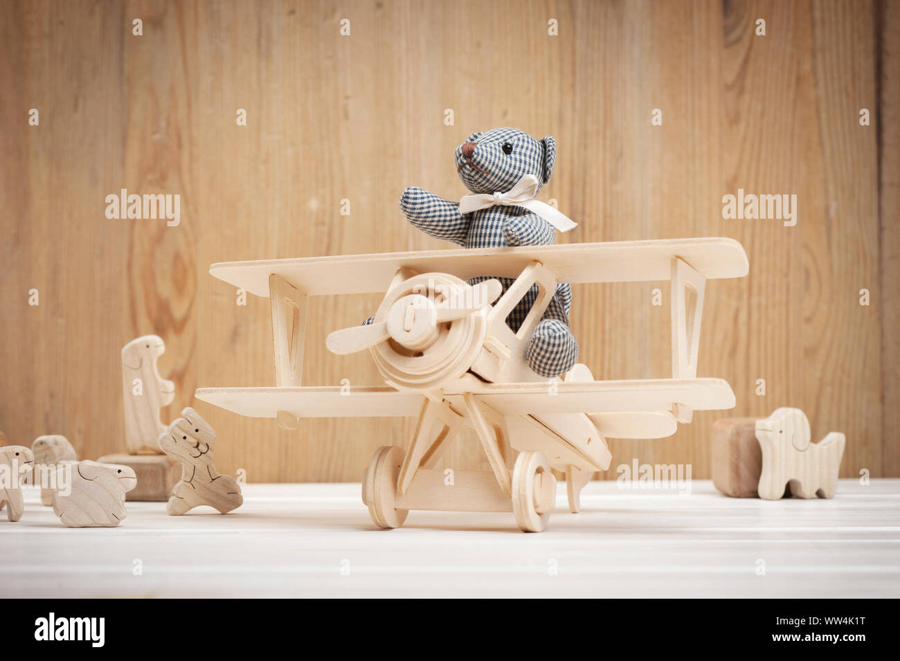Cute teddy bear on wooden background with wooden baby toys Stock Photo