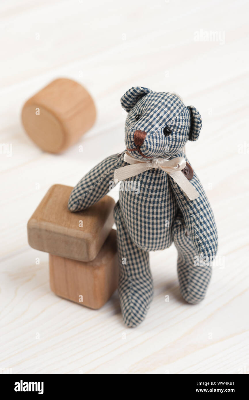 Cute teddy bear on wooden background with wooden baby toys Stock Photo ...