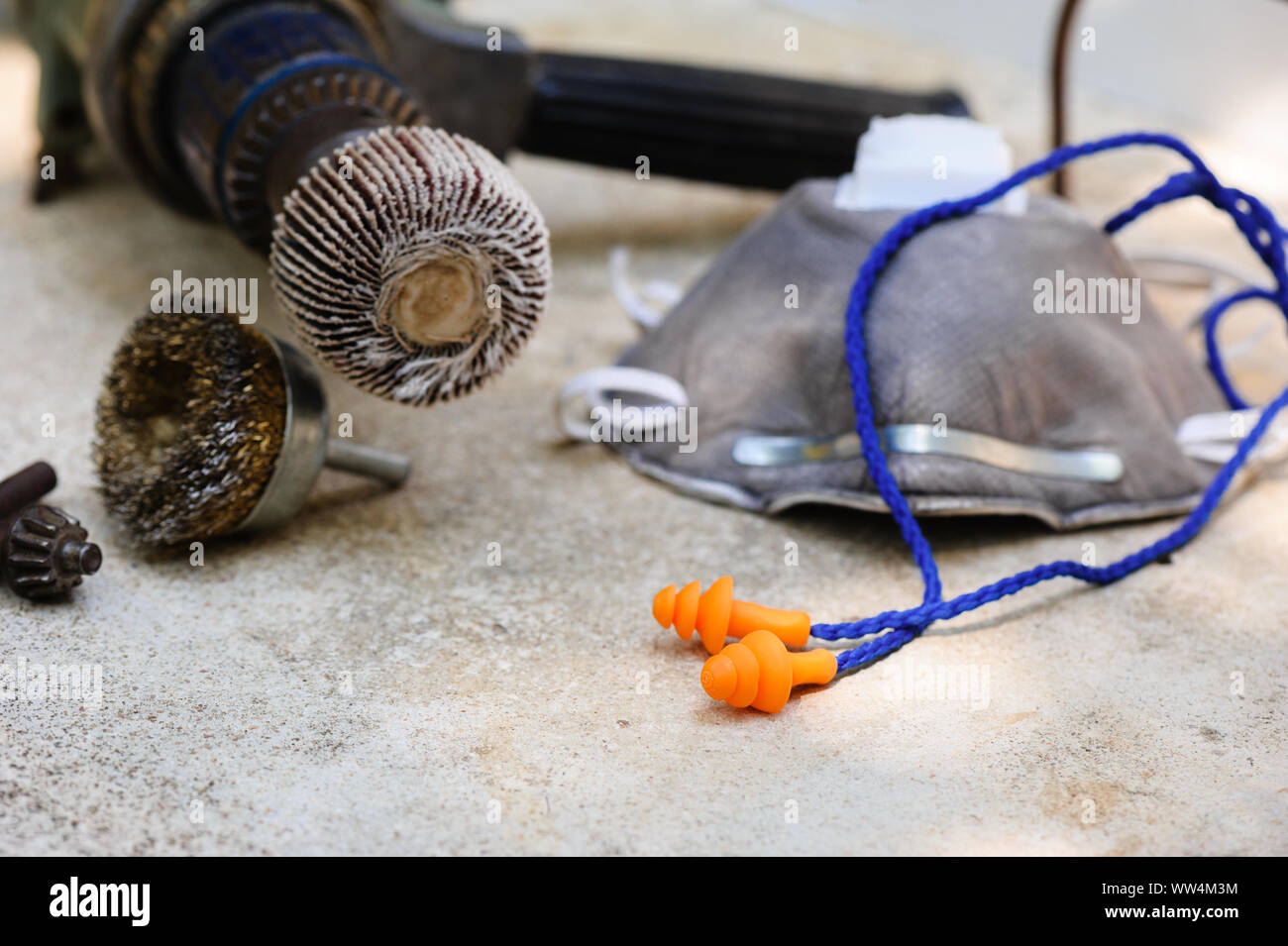 Orange reusable ear plugs in construction site, personal safety