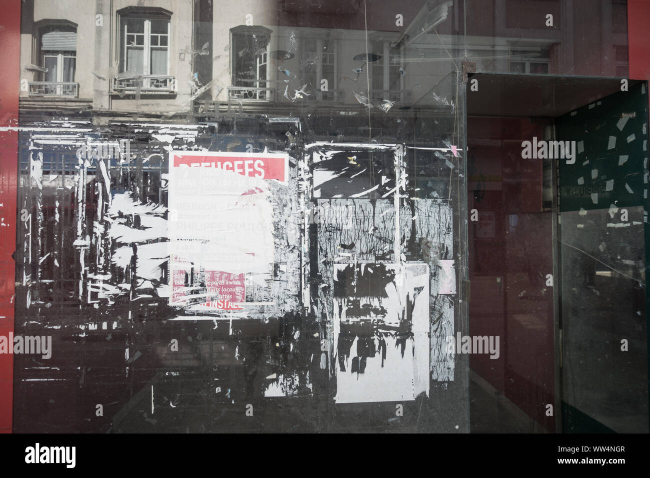 Empty shop window with old posters. Closed shop in the city of Tulle in France Stock Photo