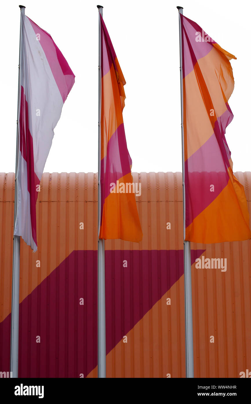 Photography of a colorful corrugated iron facade with blowing flags, Stock Photo