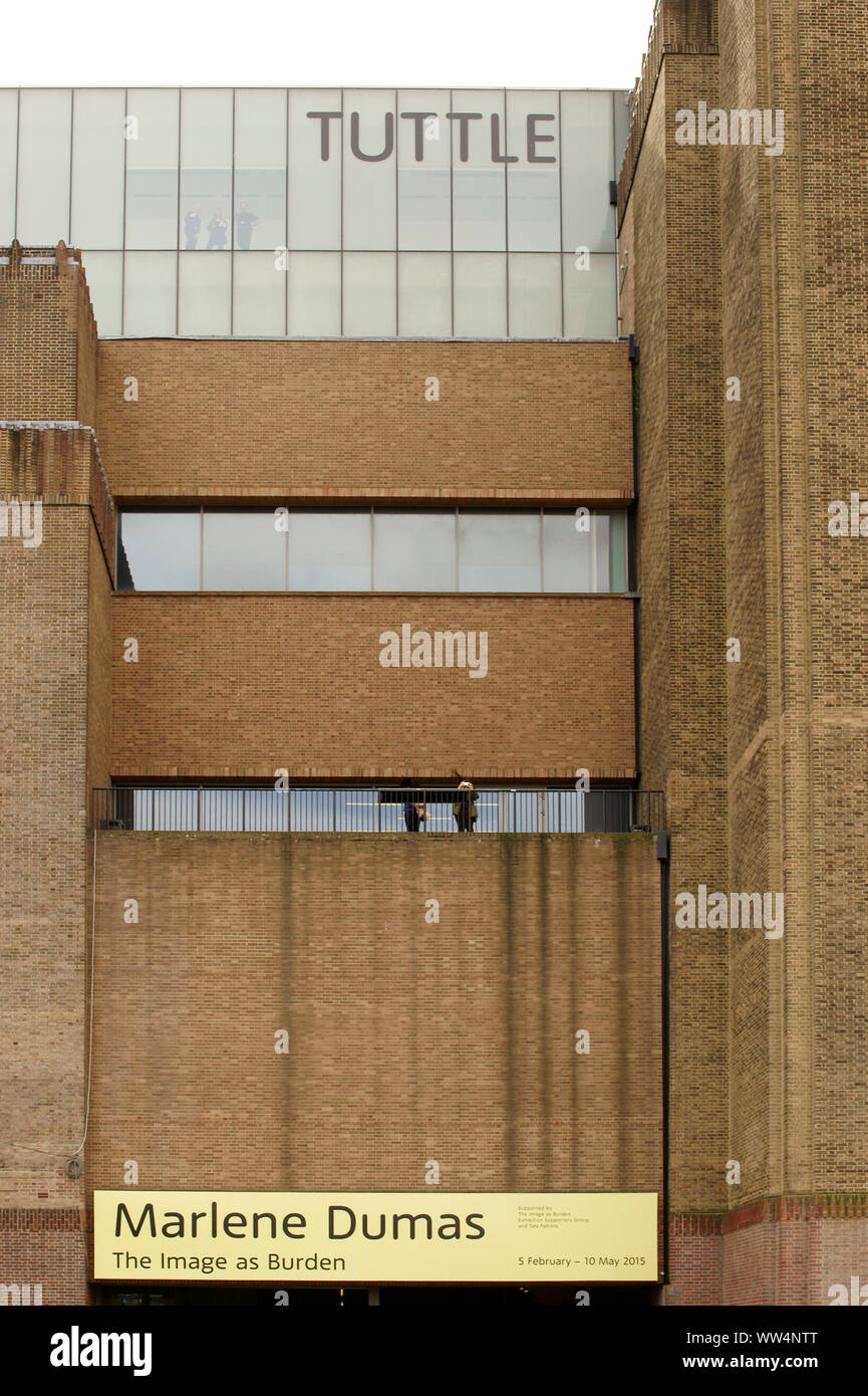 A big exhibition sign hanging under a terrace of Tate Modern museum in London, Stock Photo