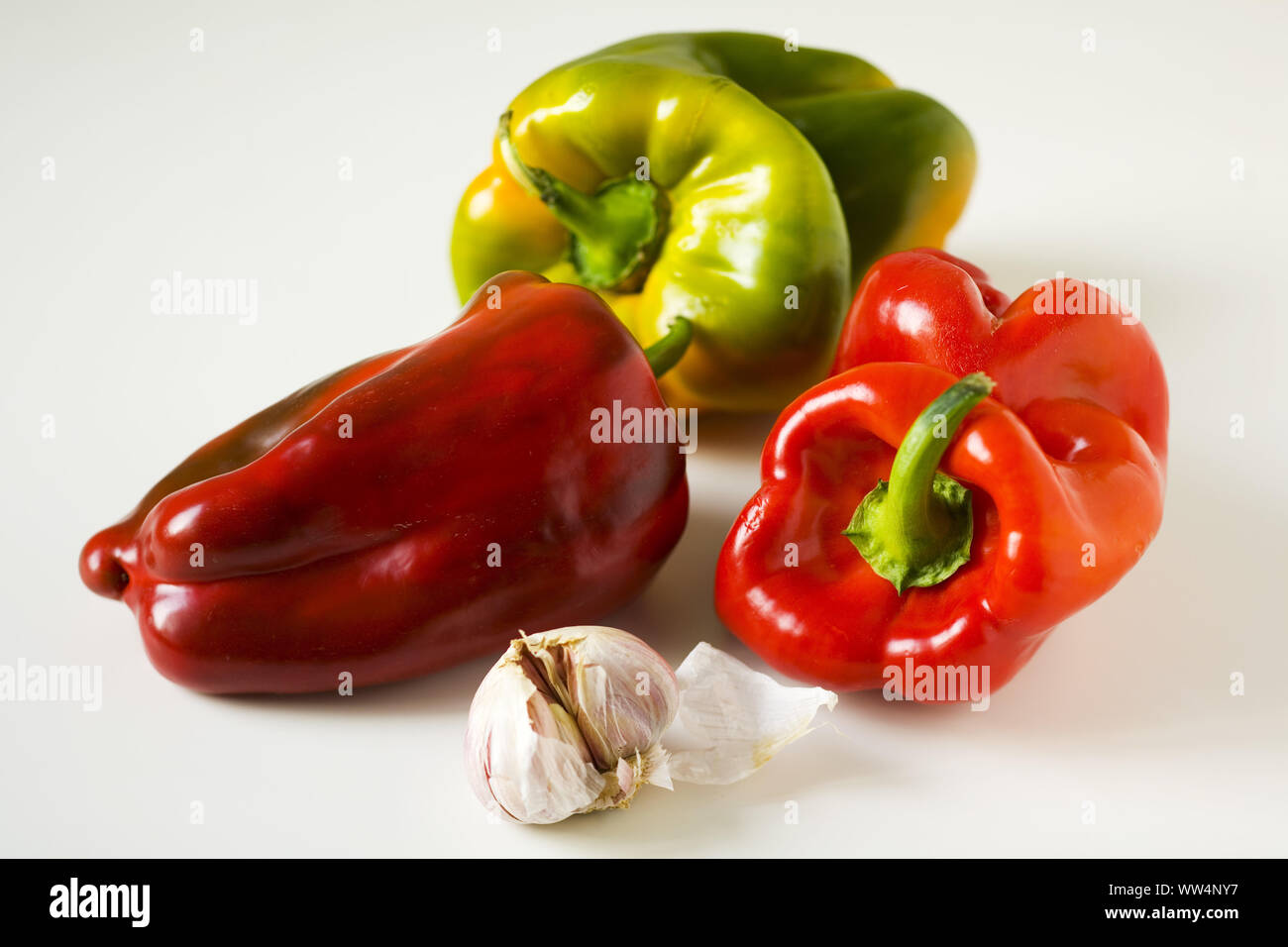Bell pepper with garlic on white background Stock Photo - Alamy