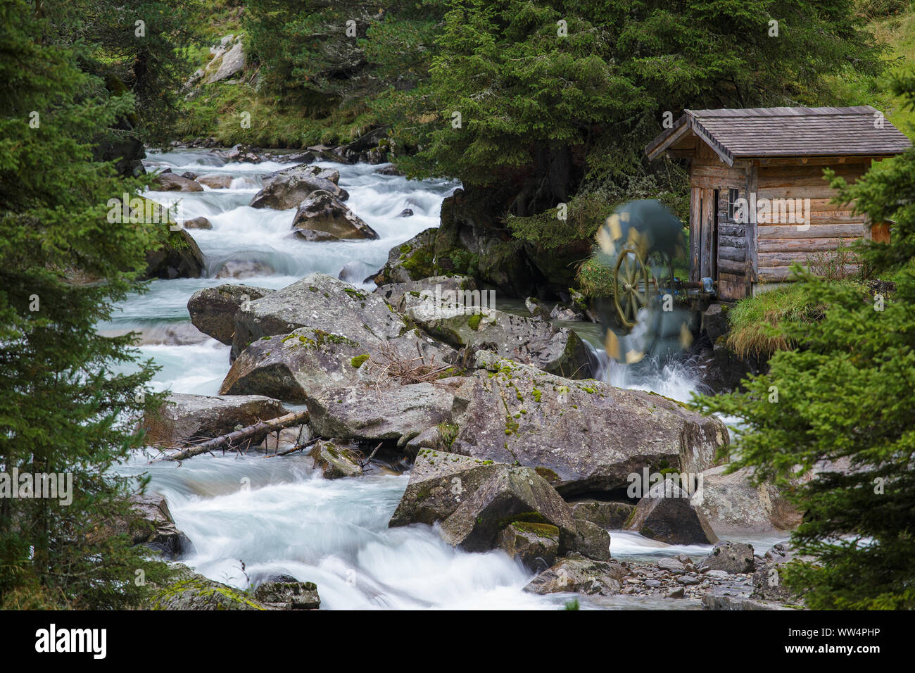 Wooden water mill. Krimmler Achen valley. Hohe Tauern National Park. Austrian Alps. Stock Photo
