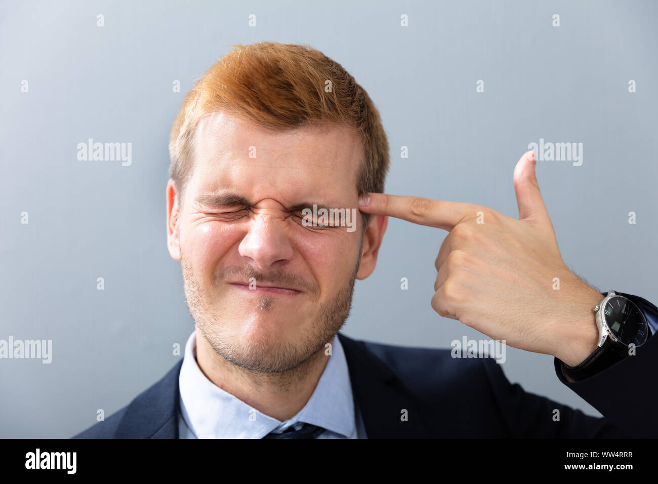 Man Making Shooting Gesture Using His Hand In Office Stock Photo