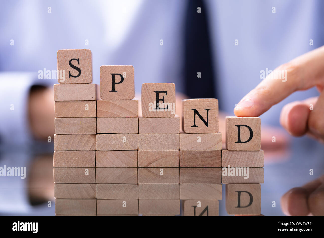 Spend Word And Man Pushing Down Chart Stock Photo