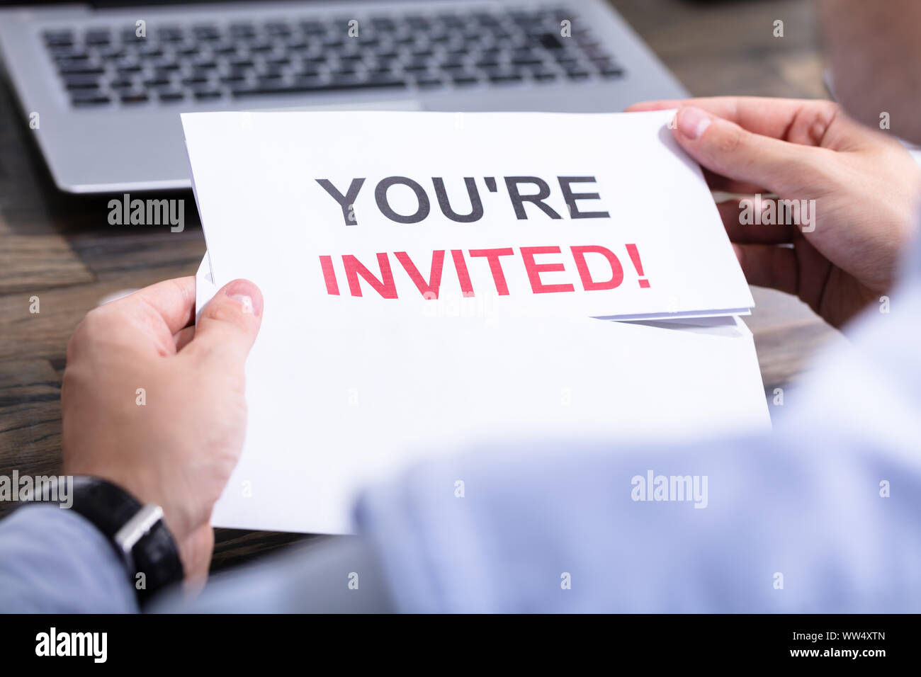 Man Opening White Envelope With You Are Invited Text Stock Photo
