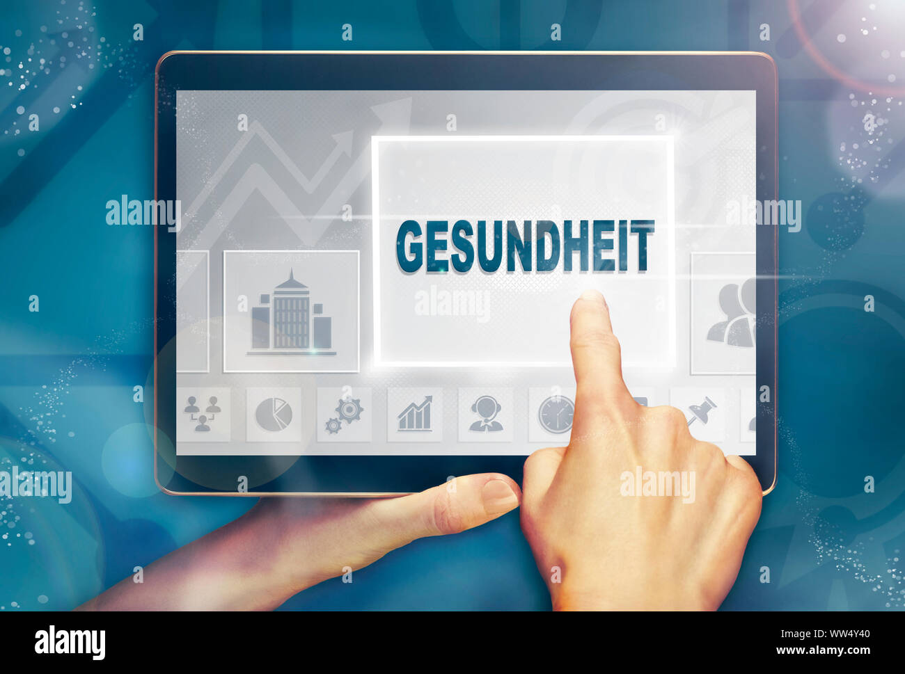 A hand holiding a computer tablet and pressing a Health "Gesundheit" business concept. Stock Photo
