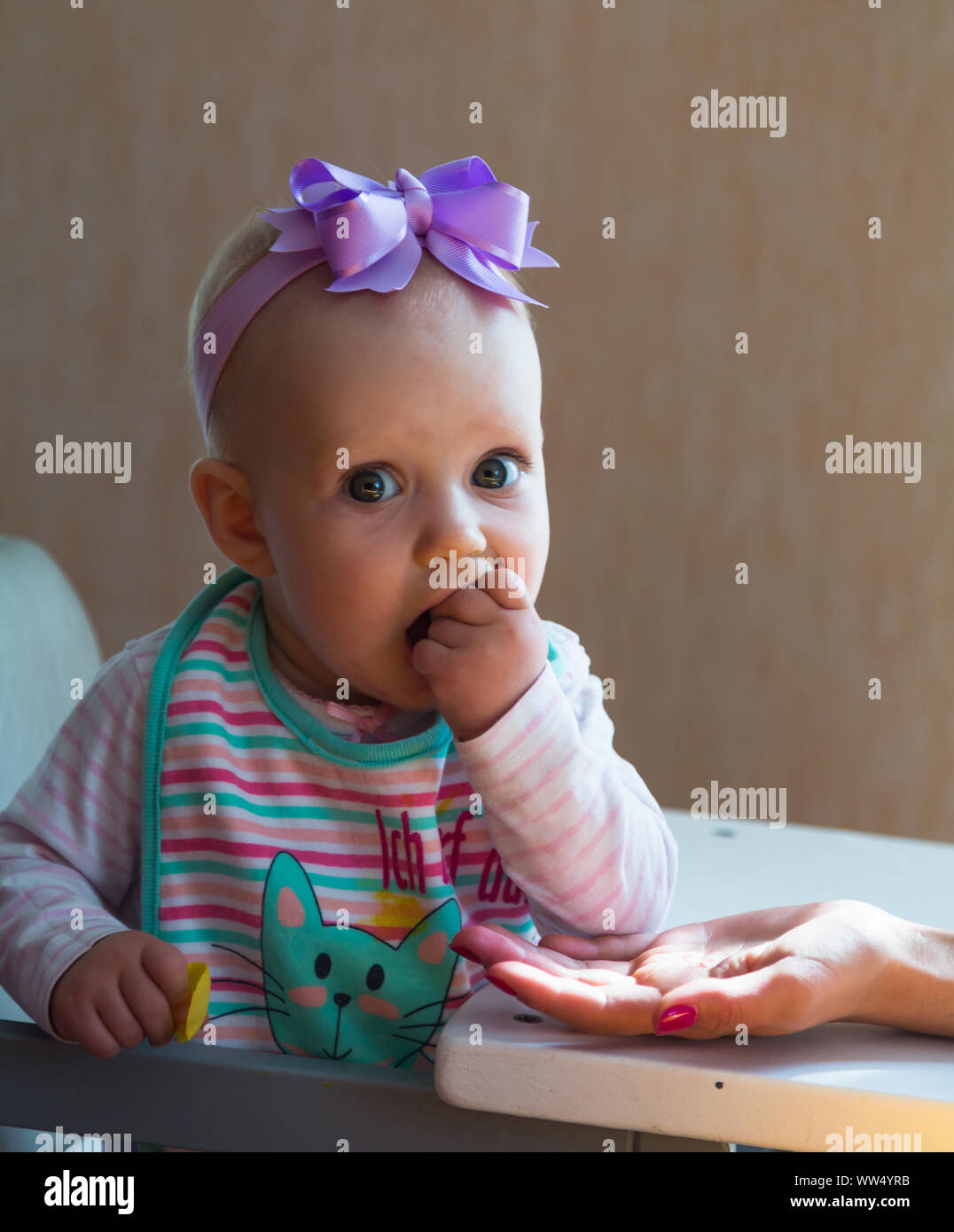One year old baby eats Stock Photo