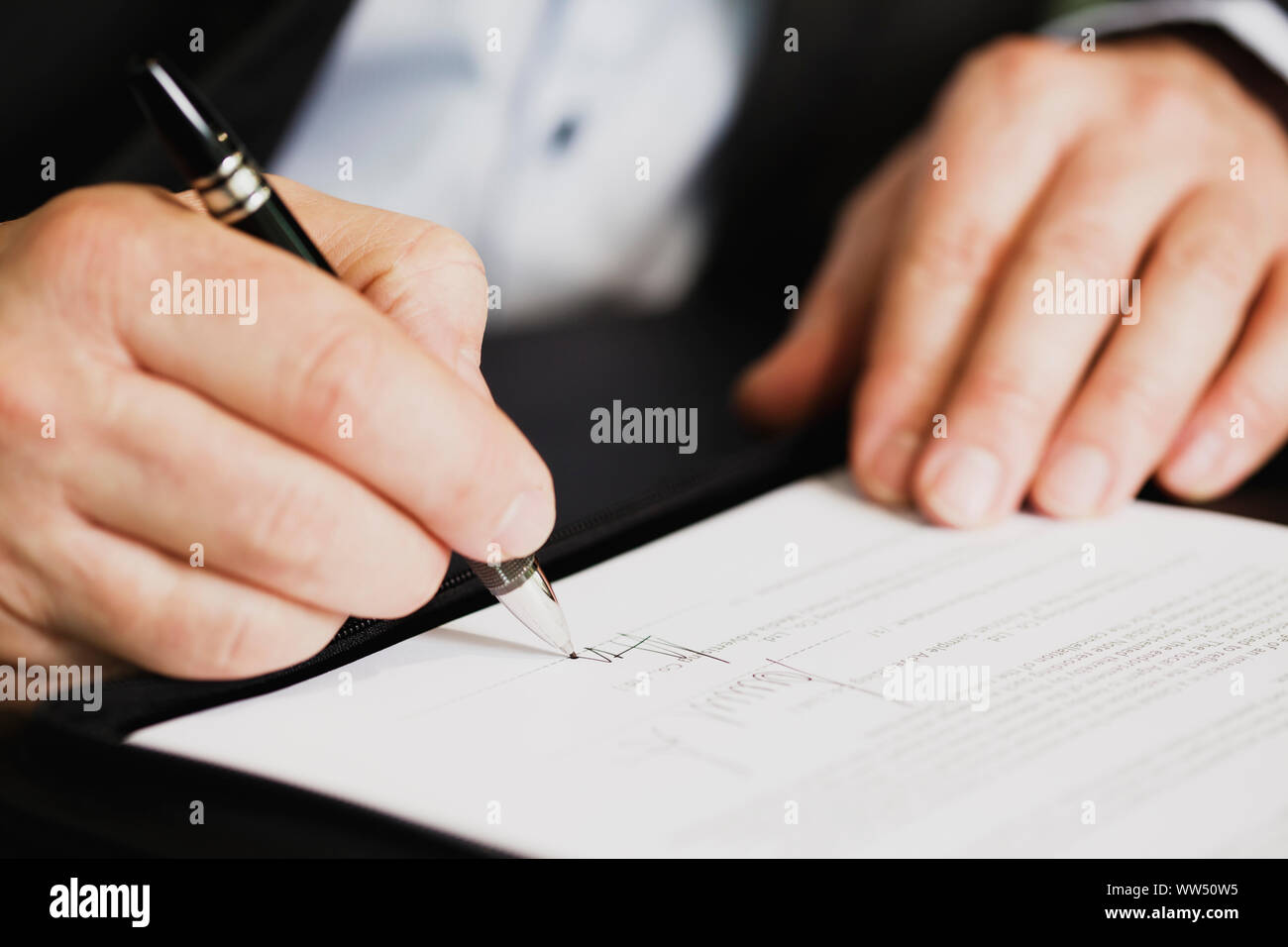 Close up of businessman signing a contract. Stock Photo