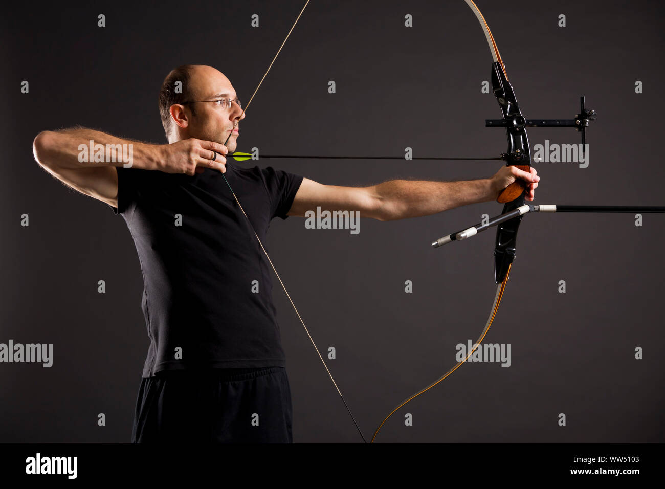 Profile of bowman with bow and arrow. Stock Photo