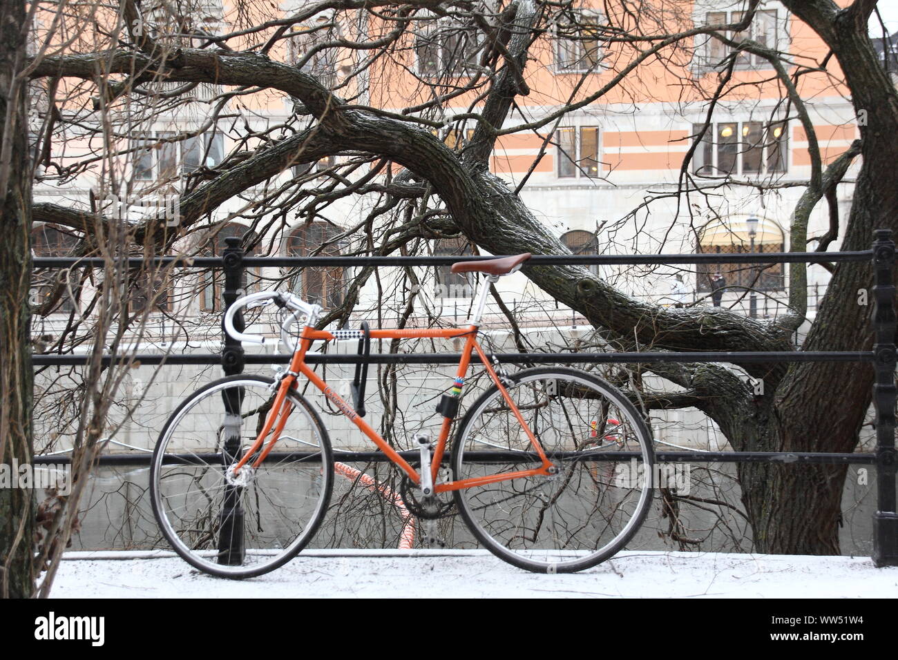 A locked racing bicycle at a railing in wintry Stockholm, Stock Photo