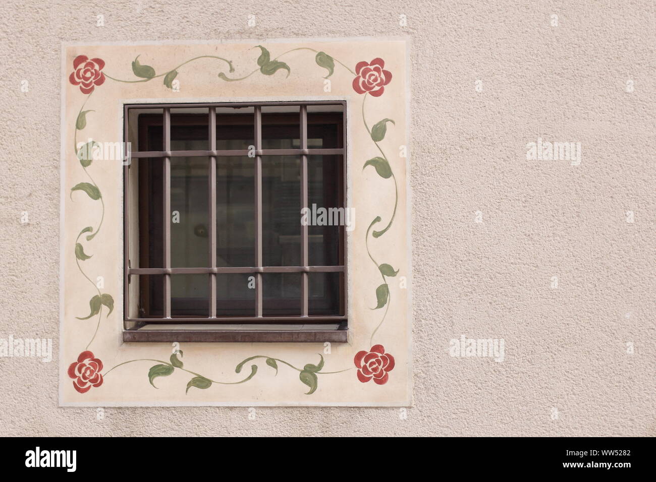 A decorated lattice window at a wall of a house, Stock Photo