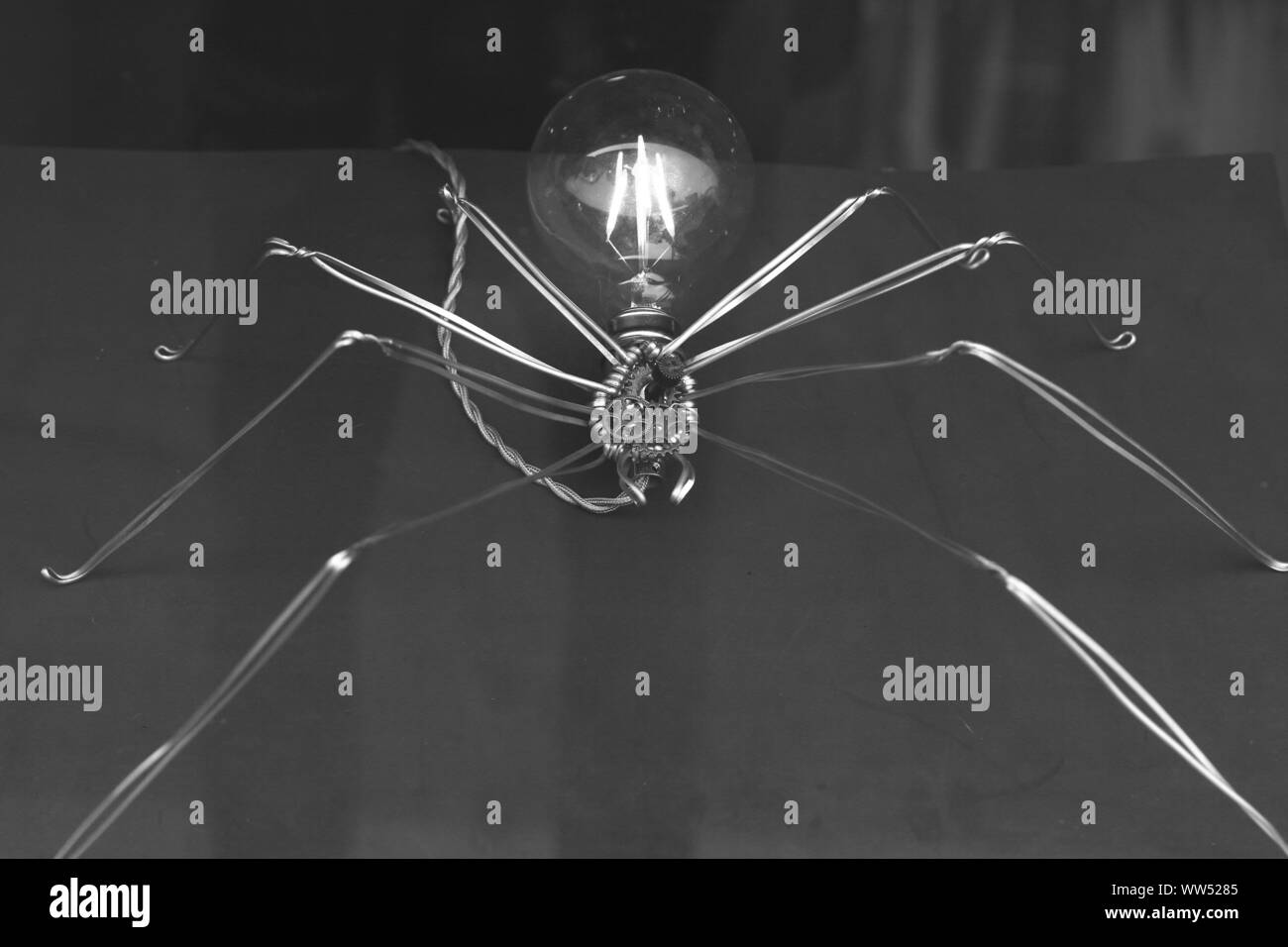 A spider from wires and a light bulb Stock Photo