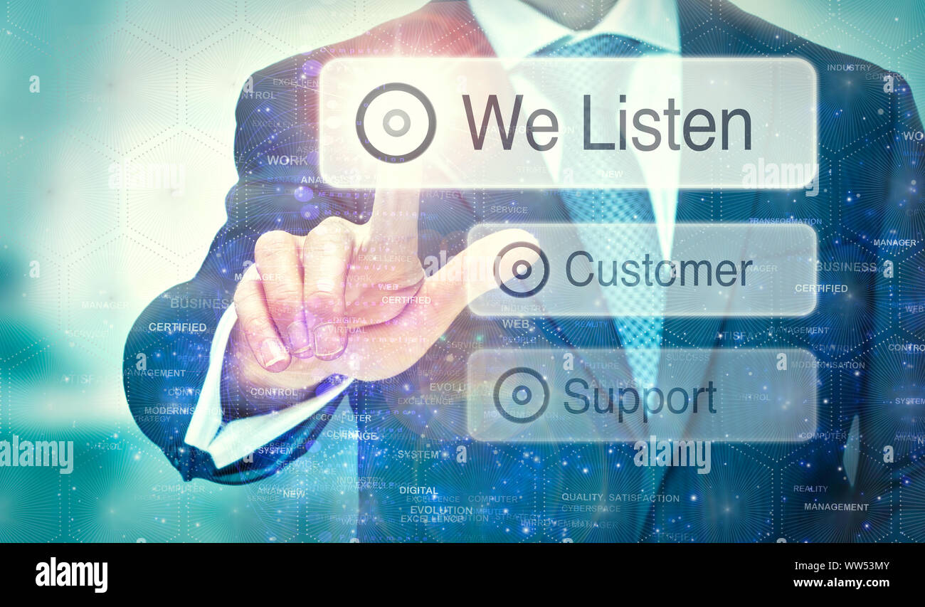 A businessman selecting a We Listen button on a futuristic display with a concept written on it. Stock Photo