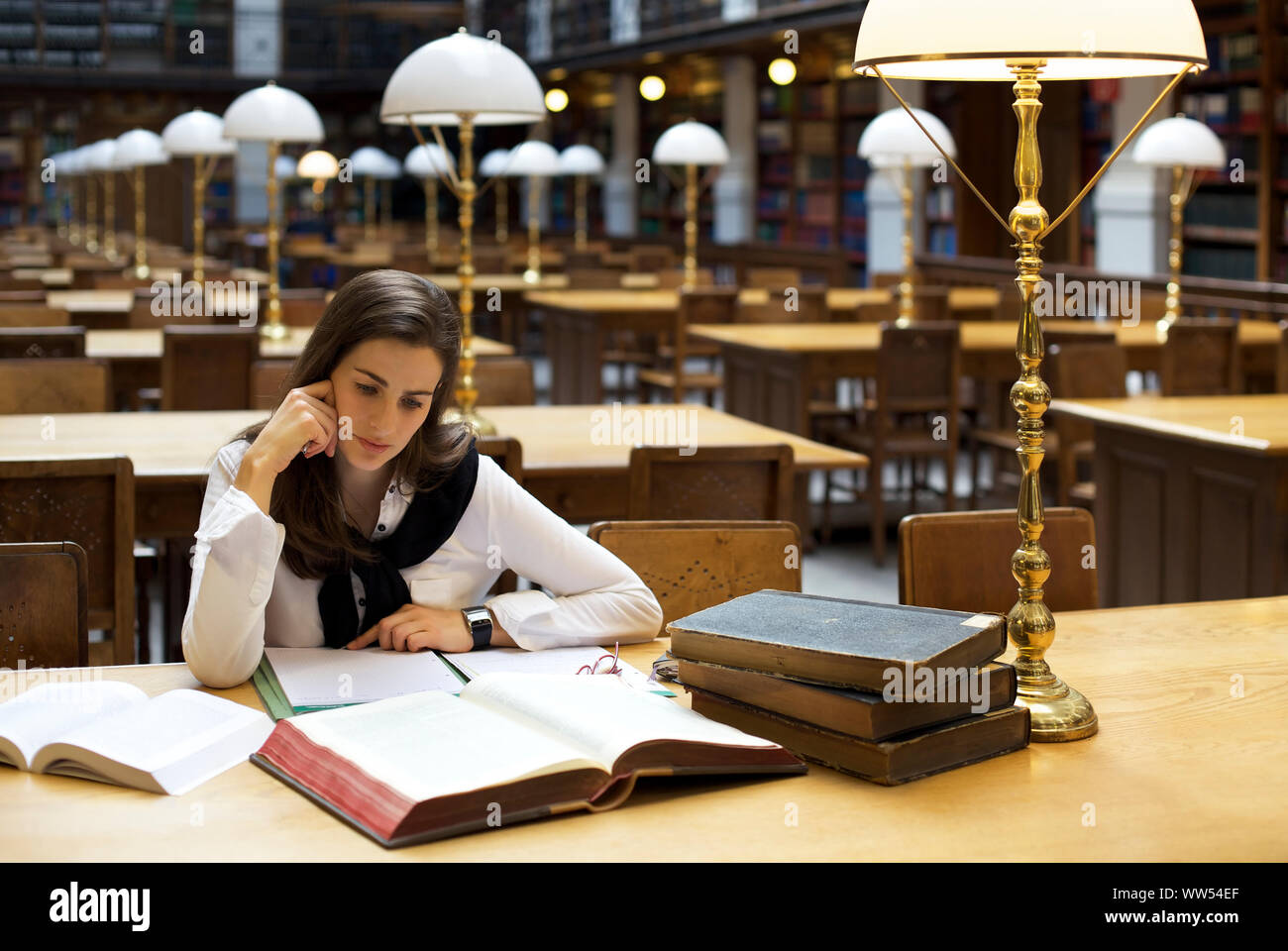 Student reading in library Stock Photo - Alamy