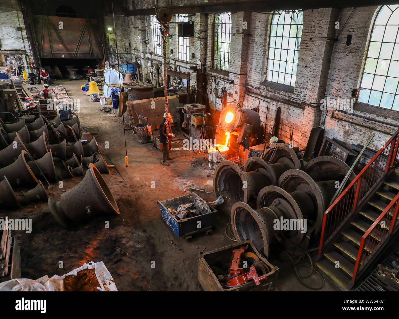 A cauldron with red hot molten metal in the foundry at John Taylor & Company Bell Foundry, Loughborough, Leicestershire, England, UK Stock Photo