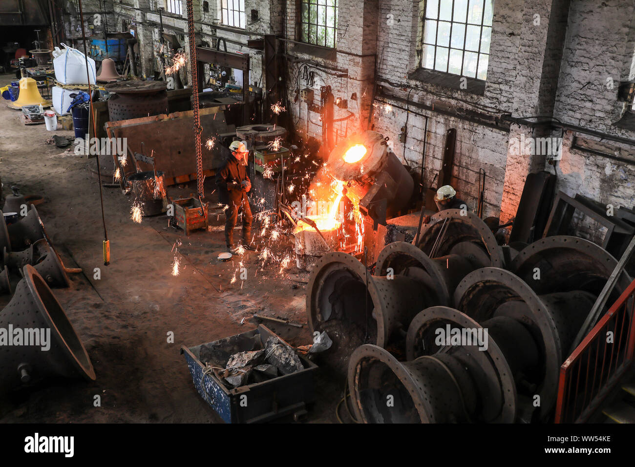 Sparks from a cauldron with red hot molten metal in the foundry at John Taylor & Company Bell Foundry, Loughborough, Leicestershire, England, UK Stock Photo