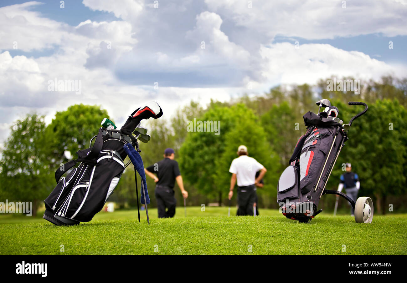 Golf bags with group of players Stock Photo Alamy