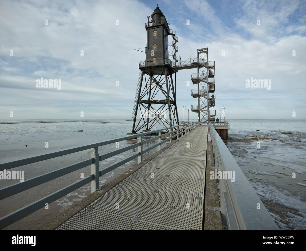 Lighthouse in the mud flats with jetty Stock Photo