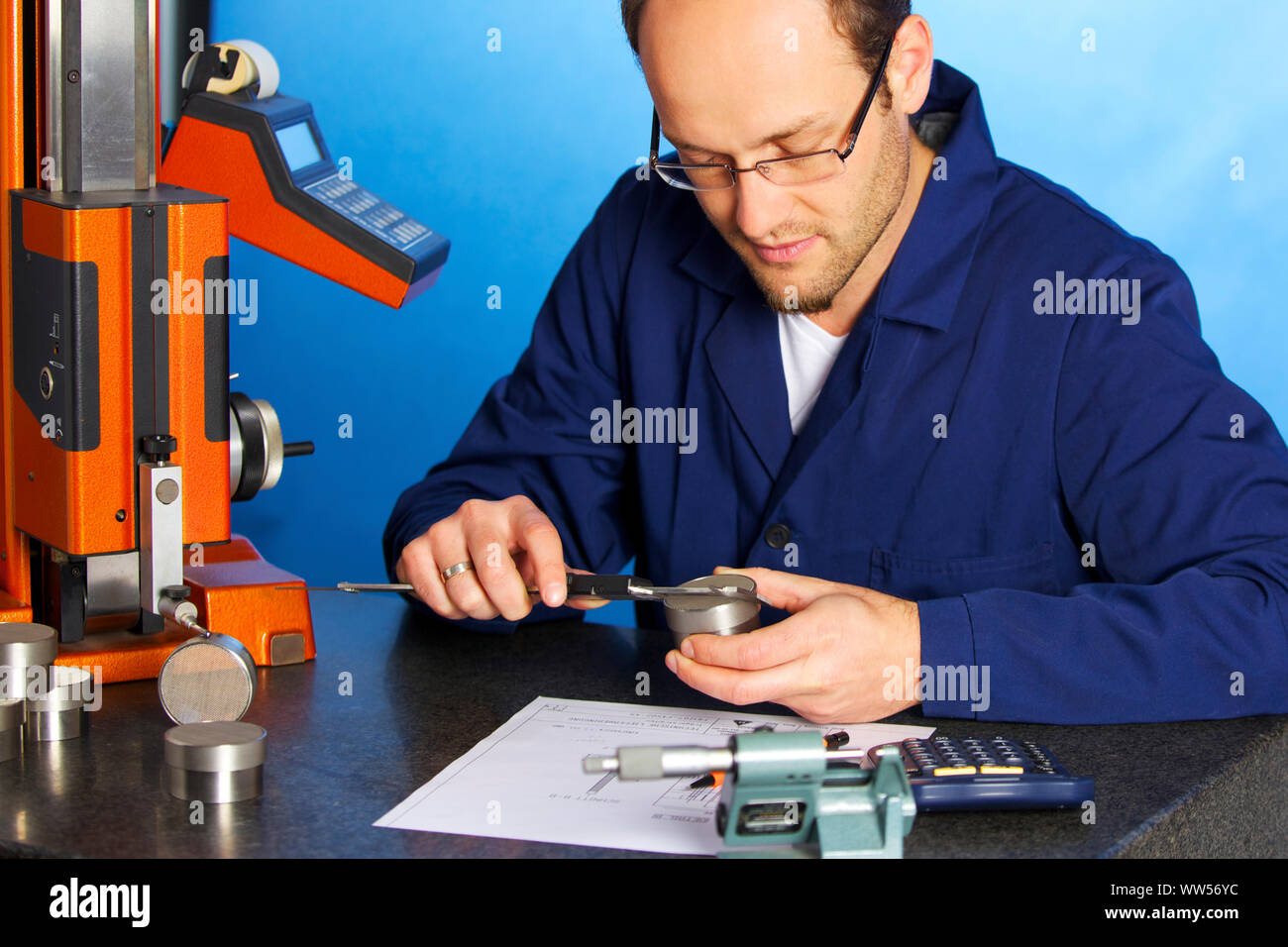 Engineer measuring with caliper Stock Photo