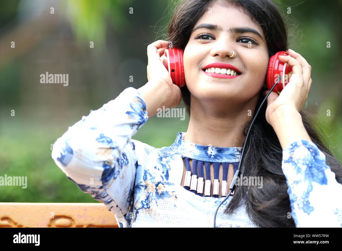 Teenage girl listening music by headphone Stock Photo