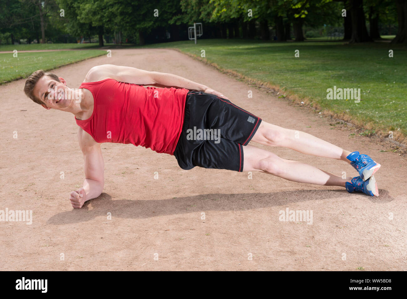 Man doing lateral push-up on track Stock Photo