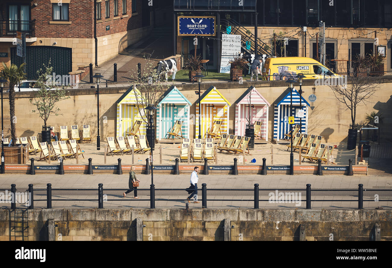 NEWCASTLE UPON TYNE, ENGLAND, UK - MAY 08, 2018: Thomas Cook's manmade Seaside with sand beach, deckchairs and colourful beach huts Stock Photo