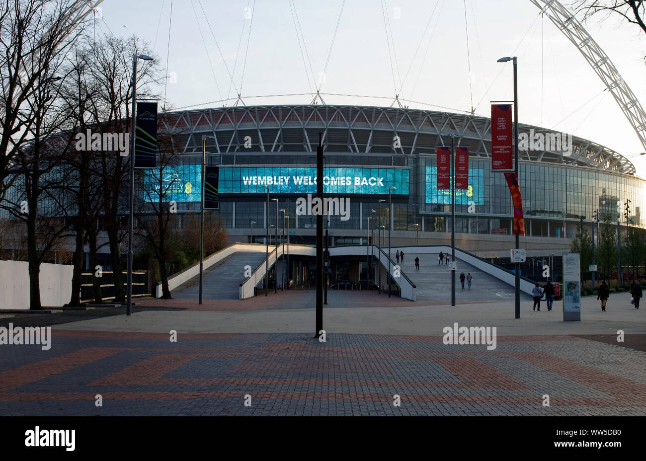 Visitors and tourists climbing up the stairs of the main entrance of the new Wembley stadium in London, Stock Photo