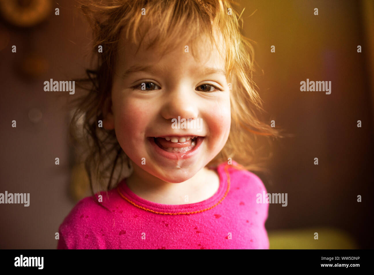 1-2 year old child with red shirt looking happily in the camera Stock Photo