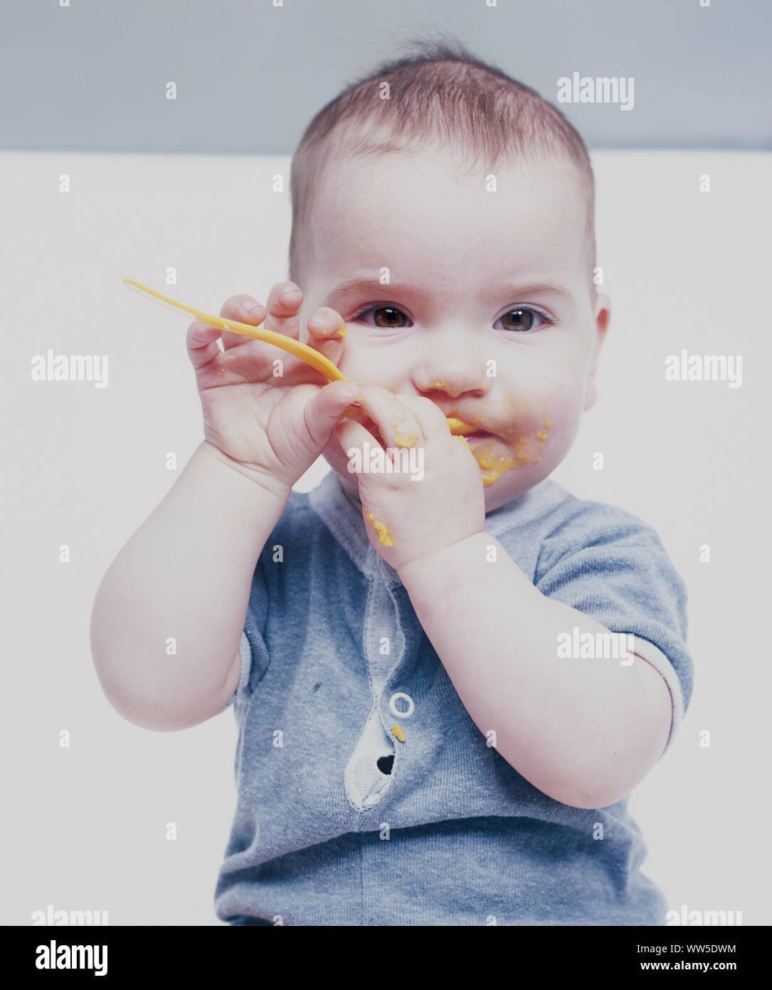 7 month-old baby with puree in the face Stock Photo - Alamy