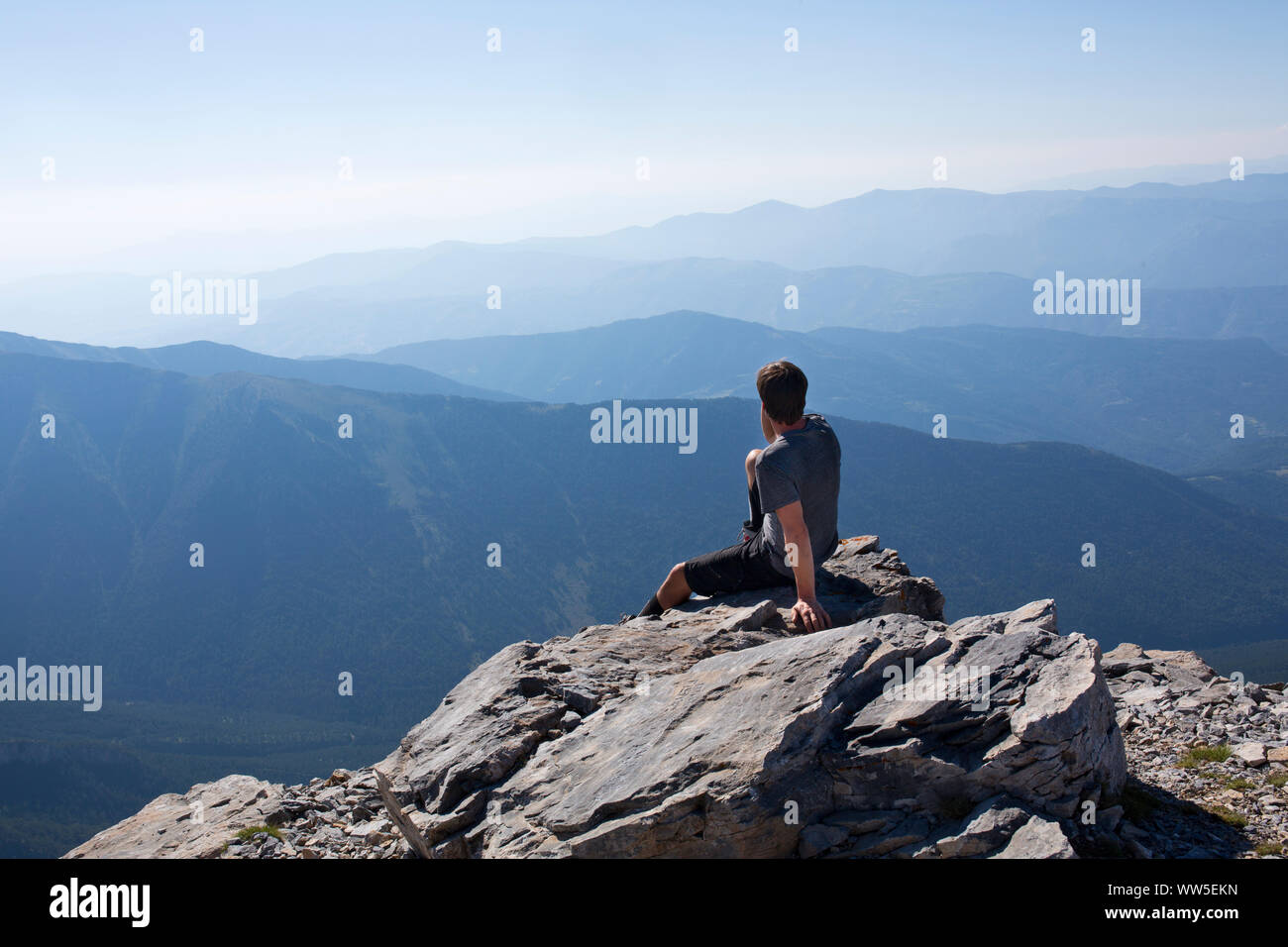 30-40 years old man at the summit of a mountain range Stock Photo