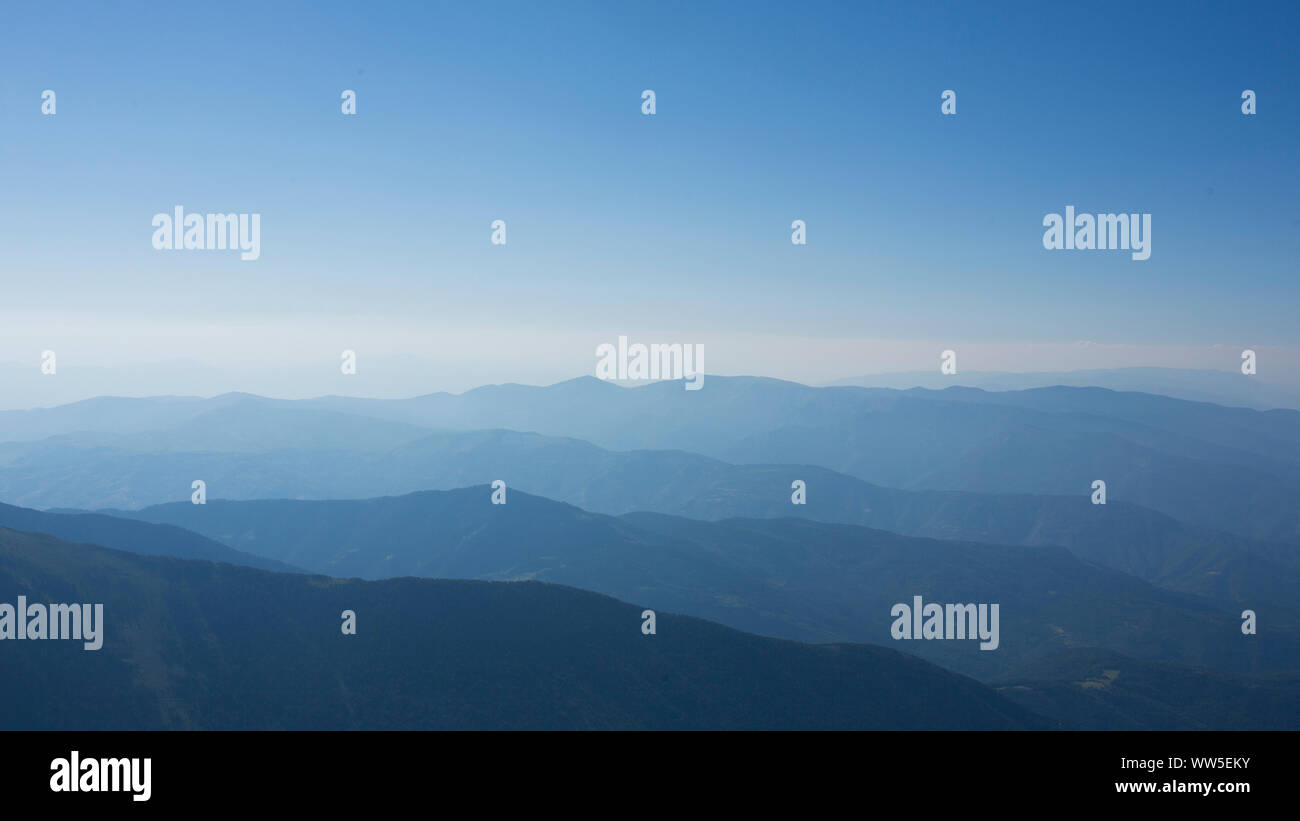 several mountain ranges in blue haze Stock Photo