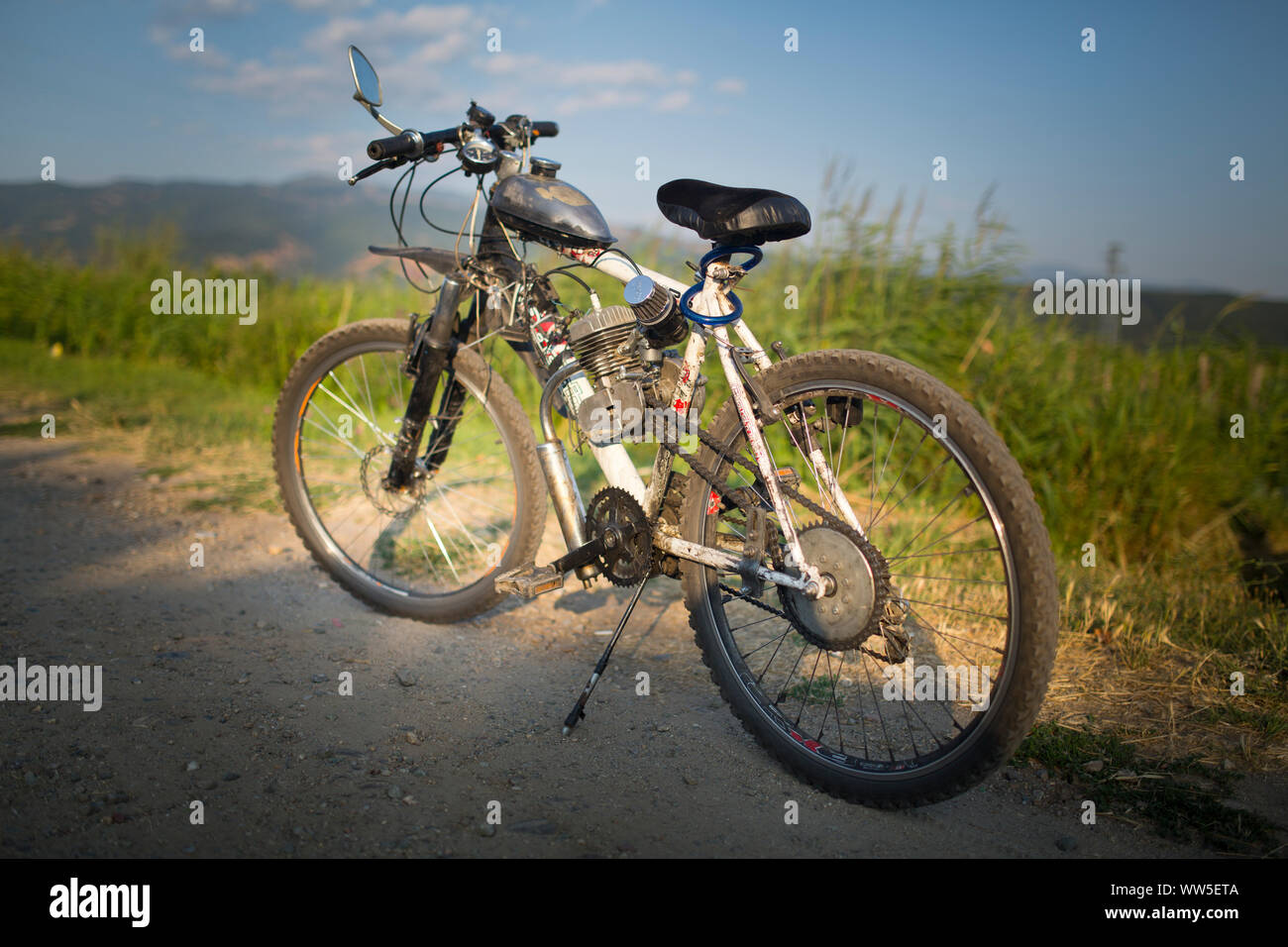 Selfmade mountain bike with engine at a country lane hires stock
