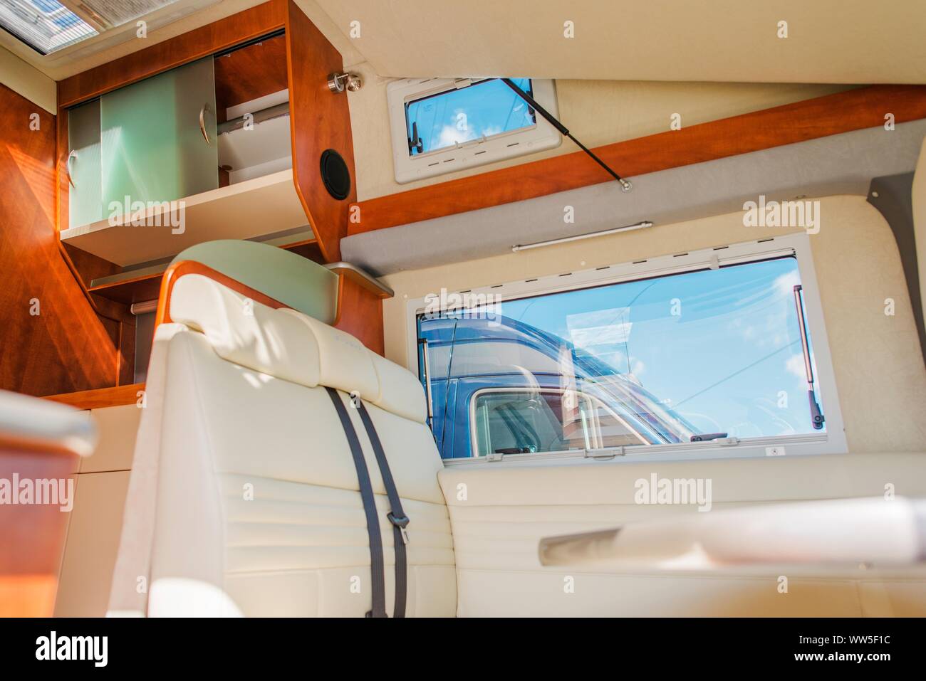 Modern Comfortable Camper Van Interior with Drop Down Ceiling Bed Stock