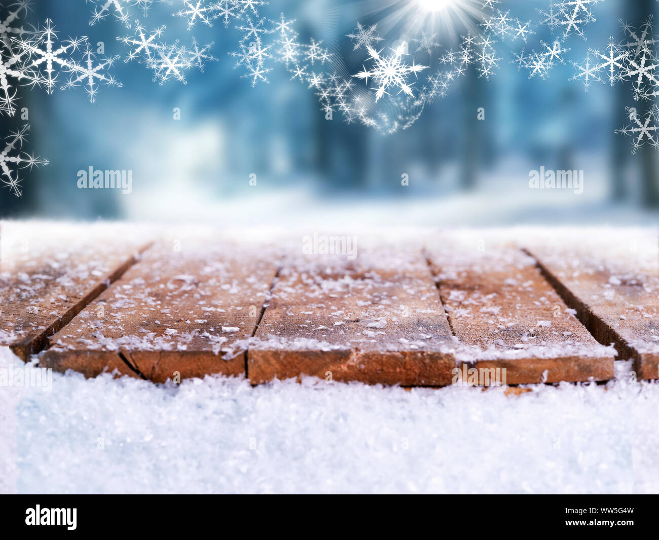 Wooden table top covered in snow with a Christmass, winter and snowy