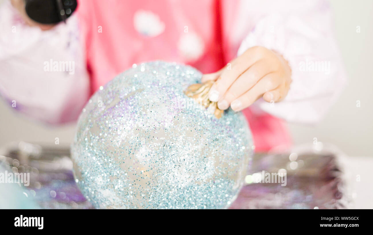 Step by step. Little girl decorating art pumpkins with glitter in ...
