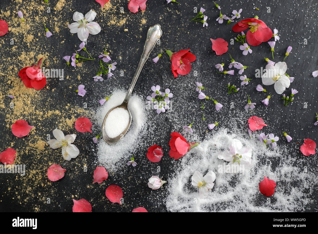 Arrangement with old silver spoon and blossoms Stock Photo