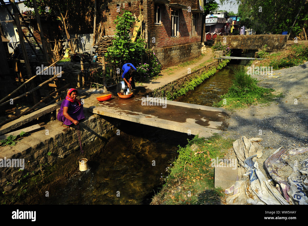 Fetching water from the old Boar canal, built by Sir Henry Ramsay in 1860 at Kalaunghi, India Stock Photo