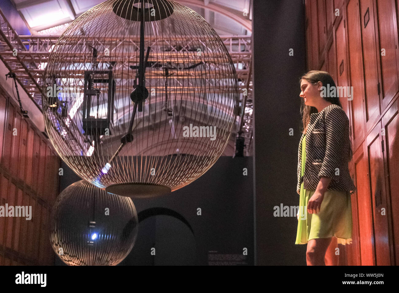 London, UK, 13th Sep 2019. An assistant engages with 'Affinity in Autonomy', an interactive installation by Sony Designs which looks at the future of AI and allows visitors to engage with a robotic pendulum. London Design Festival runs from 14-22 September 2019. Credit: Imageplotter/Alamy Live News Stock Photo