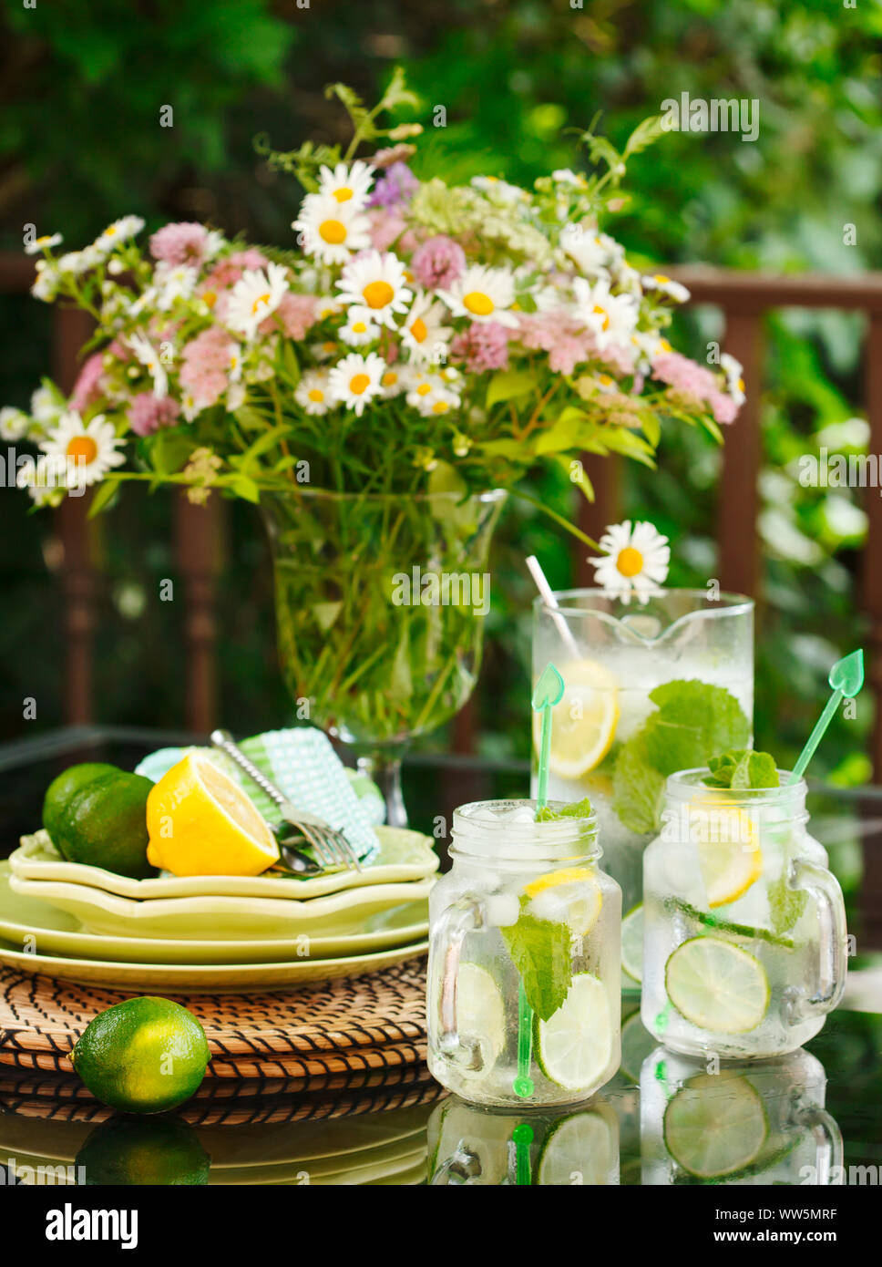 Jug and jars of Lemonade on a table in the garden Stock Photo
