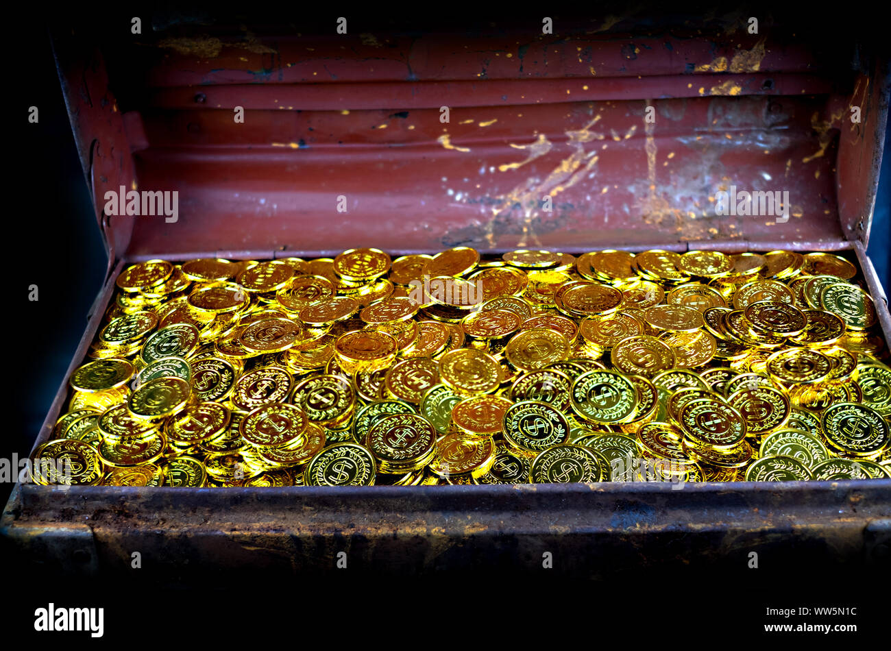 Stacking Gold Coin in treasure chest old on black background Stock