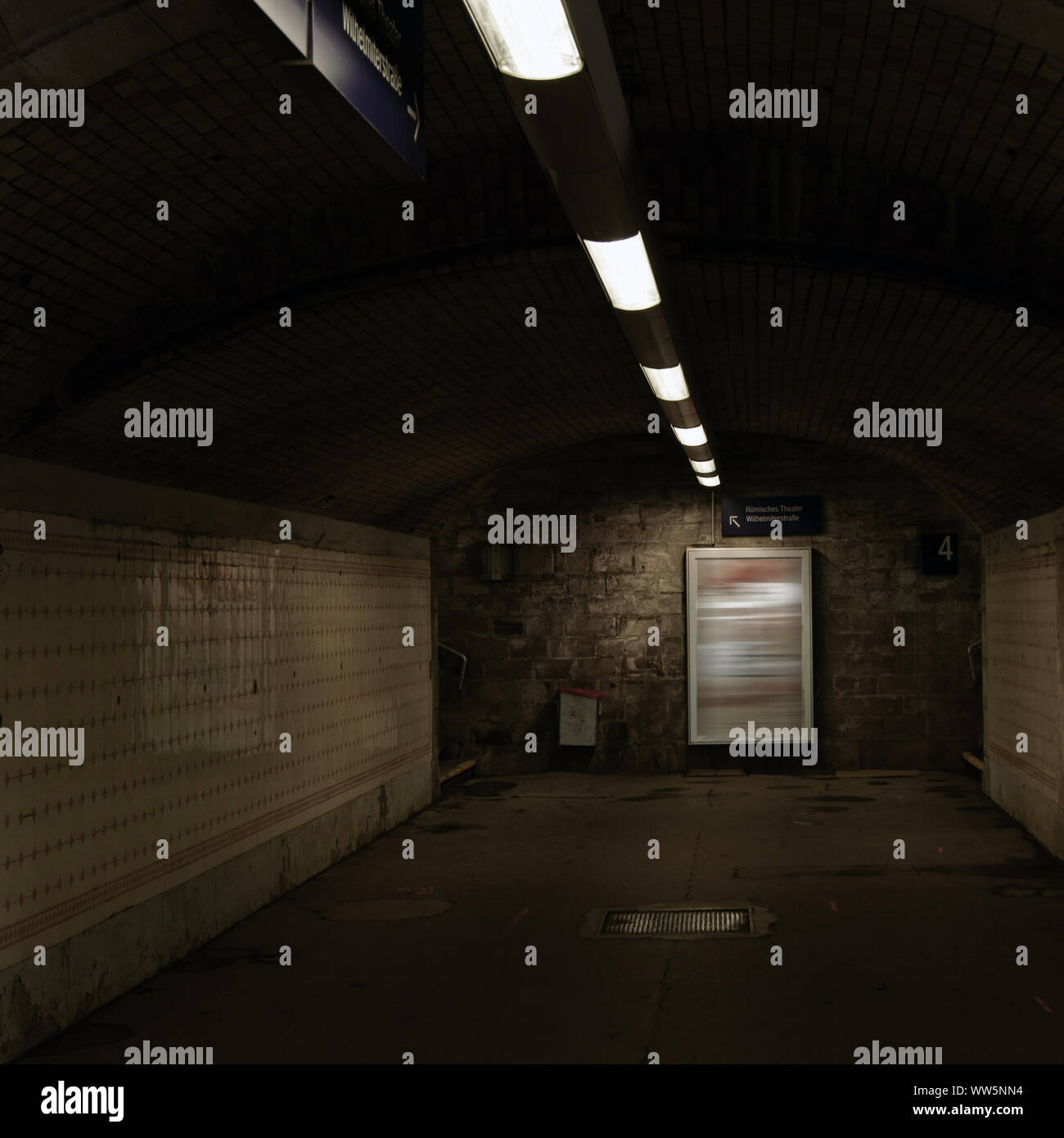 Dark railway station tunnel with artificial light and poster frame, Stock Photo